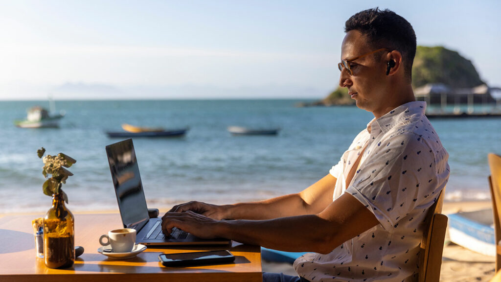 digital nomad on the beach getting a job done